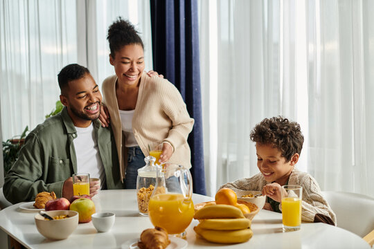African American family sharing a heartwarming breakfast together at the dining table.
