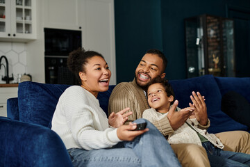 African American family bonding on blue couch.
