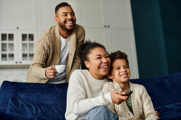 African american family enjoying a serene moment seated on a blue couch.