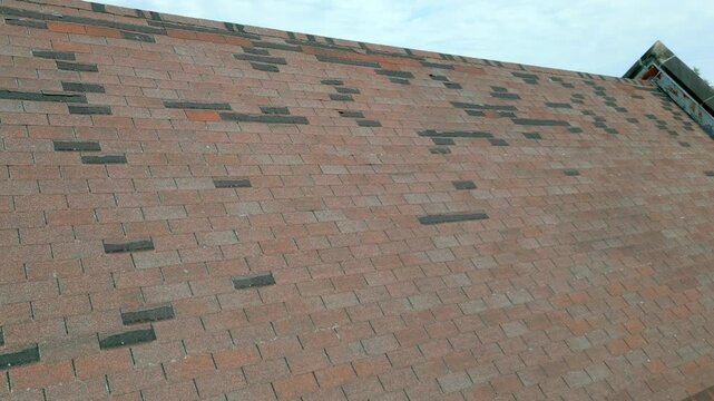Roof in need of repair, missing shingles from storm damage