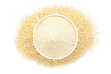 A bowl of Organic Rice (Oryza sativa) Flour, placed over a heap of Rice. Isolated on a white background.
