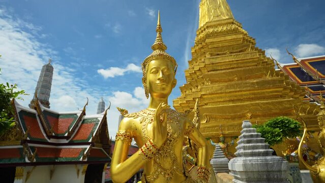 Golden angel statue at the Buddhist Temple Wat Phra Kaew grand Palace emerald buddhist temple at Bangkok, Thailand