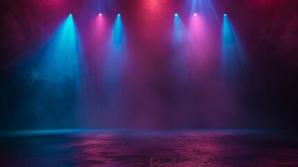 A darkened stage with blue and purple spotlights