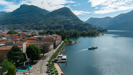 Ferry leaving the harbor in Lugano, Switzerland, Scenic Aerial Drone Photo