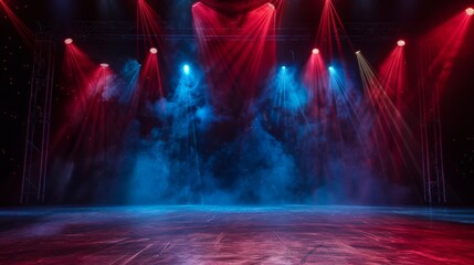 A dark stage with red and blue spotlights illuminating the floor