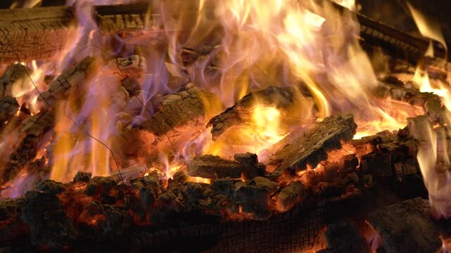 Macro shot bonfire made of logs in a brick firepit showing camping in the desert in rajasthan or the hills of shimla, manali and more with cold chilly evenings