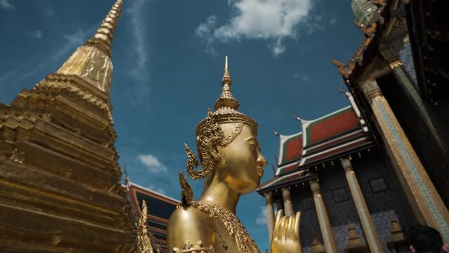 Golden angel statue at the Buddhist Temple Wat Phra Kaew grand Palace emerald buddhist temple at Bangkok, Thailand
