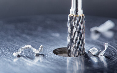 Milling cutter make sink in hole in steel billet. Locksmith work.