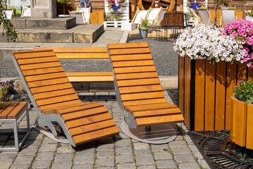 Curved benches for resting one person reclining in a city street. Rocking chair on the square.