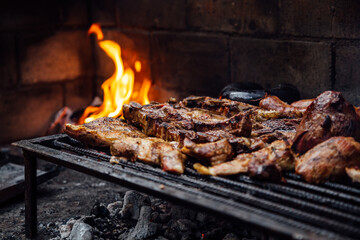 Barbeque, bbq meat cooking on grill. Traditional Asado of Argentina, Paraguay y Uruguay.