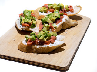 sandwiches with red fish and avocado on white bread