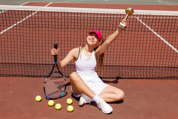 Excited young female tennis player celebrating victory on the card, tennis cup, victory in tennis