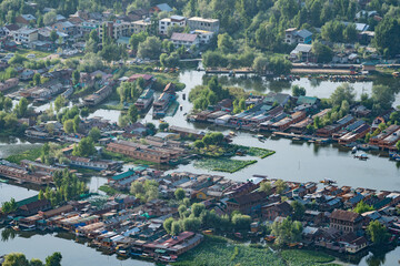 A city surrounded by water and trees, blending urban and natural elements