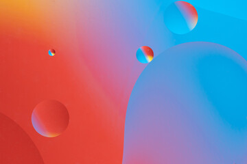 Colorful abstract background with dynamic bubble shapes. Red and blue gradient.