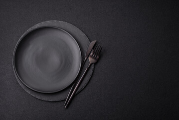 Empty round slate plate for template on the black background