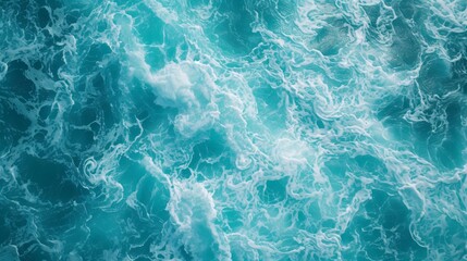 Obraz premium Foamy texture background of turquoise sea, Crashing waves on the beach, Blue ocean surface, top view.