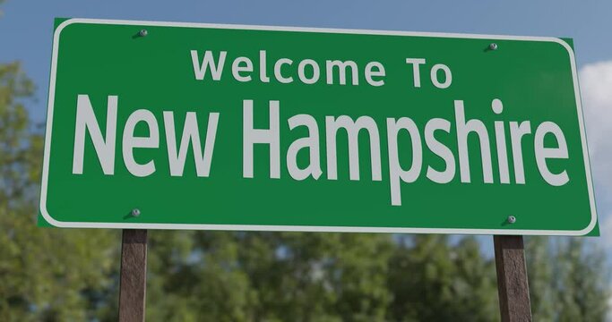 Driving By A Welcome To New Hampshire Green Road Sign Against a Blue Sky and Clouds.

