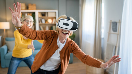 Women two senior females at home enjoy virtual reality VR headset