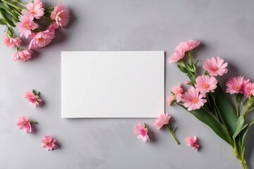 Obraz premium Blank card on the table and bouquet of pink flowers next to it. Copy space. Love letter concept 