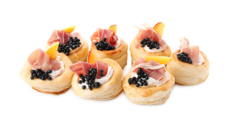 Delicious puff pastry with cream cheese, ham, black caviar and peach isolated on white