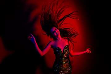 Obraz premium Photo of gorgeous young lady dance throw hair wear dress isolated on red blue color neon background