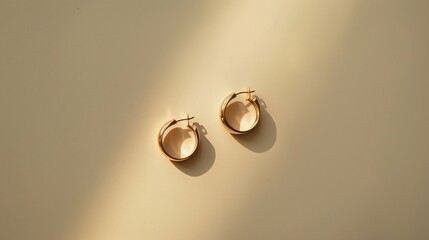 A pair of minimalist earrings displayed on a plain, white background