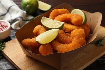 Delicious breaded fried shrimps and lime on table, closeup