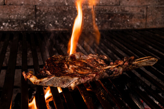 Succulent steak grilling over open flames on a barbecue
