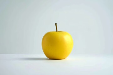one yellow apple on a white isolated background