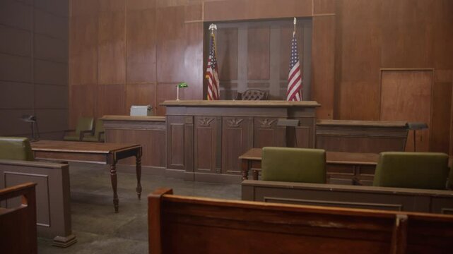 Slider shot of empty court room with wooden walls