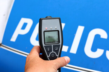 Alkomat. Nietrzeźwy kierowca samochodu zatrzymany przez policję badania alkomatem. © FotoDax