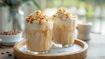 Iced caramel macchiatos with whipped cream and caramel drizzle