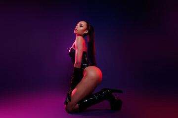 Profile side photo of african american girl feel passionate sit wear leather suit boots over neon background