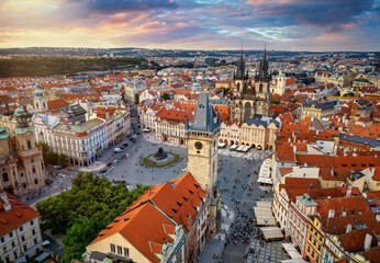 Elevated sunset view of the town square in the old city center of Prague, Czech Republic, with Tyn Church and Astronomical Clocktower