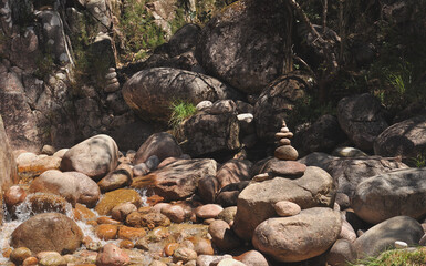Zen concept stacked stones, in a mountain river with water falling between the stones, mariola, unwind, relax, therapy, spa