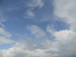 The sky is blue with a few clouds scattered throughout. The clouds are white and fluffy, giving the sky a peaceful and serene appearance
