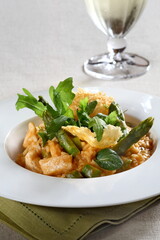 Asparagus risotto with pirarucu and fried cassava chips