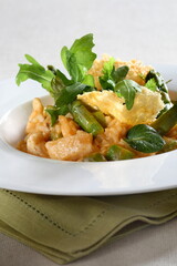 Asparagus risotto with pirarucu and fried cassava chips