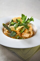 Asparagus risotto with pirarucu and fried cassava chips