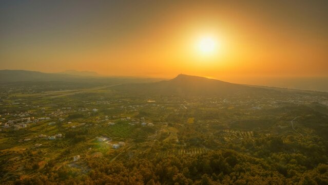 View from Filerimos hill in southwest direction, wide landscape with mountains at sunset in orange sky, Filerimos, hill not far from Rhodes town, Ancient State of Ialyssos, Rhodes, Dodecanese, Greek