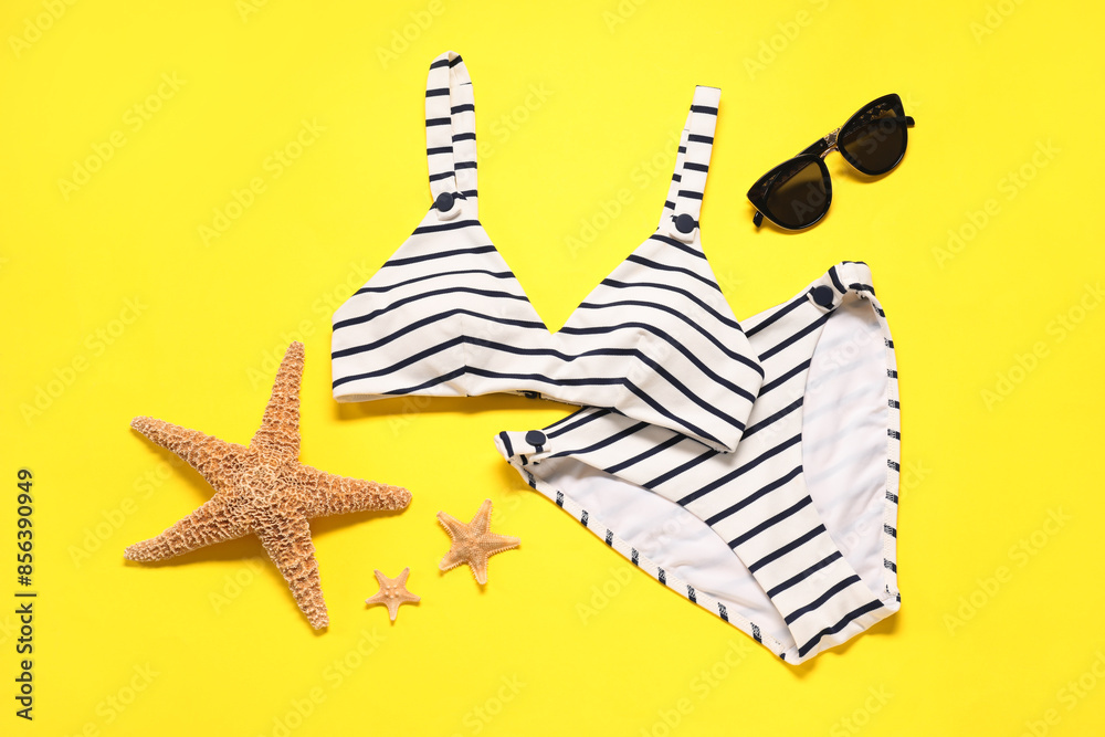 Sticker Flat lay composition with striped swimsuit and sunglasses on yellow background