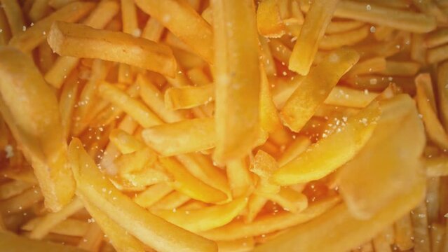 Super Slow Motion Shot of Falling French Fries and Salt Followed by Camera at 1000 fps.