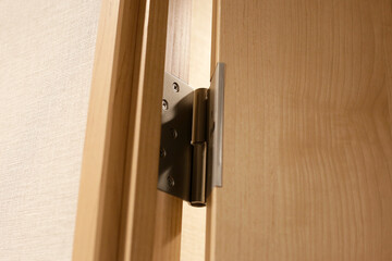 Wooden door with stainless door hinges