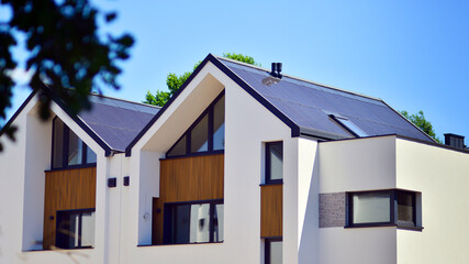 Terraced family homes in newly developed housing estate. The real estate market in the suburbs. New single family houses in a new development area. Residential homes with modern facade. 