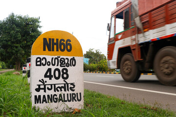 mile stone sign board (travel guide) located beside of national highway in kerala india