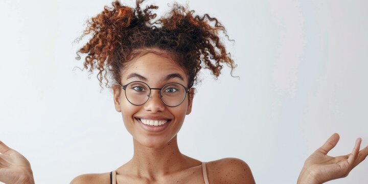 Cheerful biracial woman with curly hair smiling confidently in casual attire, wearing glasses with a white background. Copy space. - Powered by Adobe