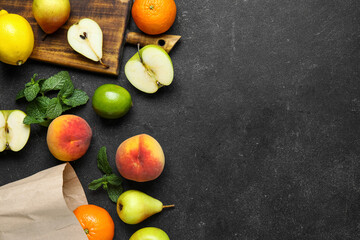Wooden board with fresh fruits on grunge black kitchen table