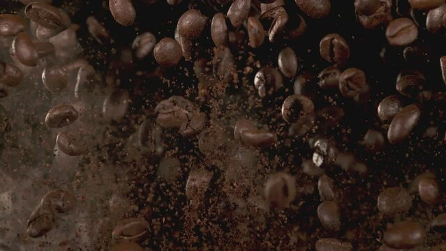 Super Slow Motion Shot of Flying Premium Coffee Beans, Ground Coffee and Smoke at 1000fps.