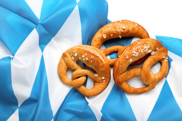 Soft pretzels and flag of Bavaria on white background