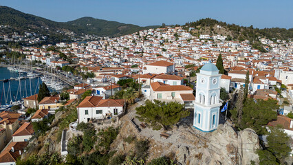 Obraz premium Aerial panorama of the city and harbor of Poros island in the Saronic Gulf, Greece, during a colorful summer sunset